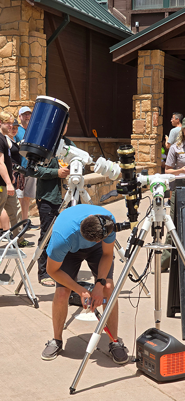 Bryce Canyon Astronomy Festival visitors observe the sun through a telescope with a filter