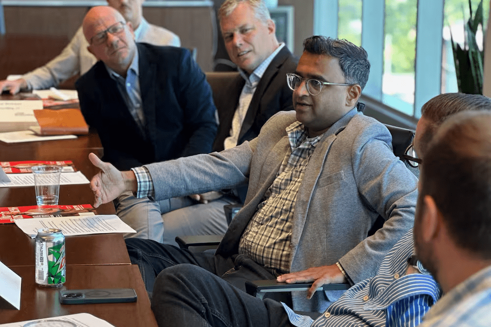 A group of professionals discussing around a conference table.